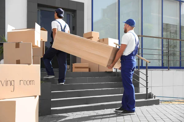 depositphotos_213086654-stock-photo-male-movers-carrying-shelving-unit
